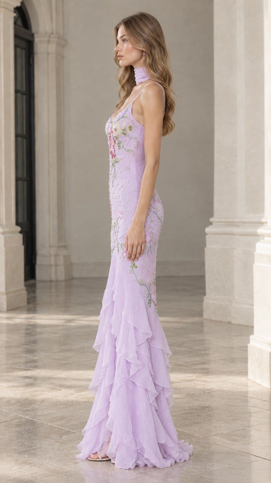 Side profile of model wearing lavender mermaid evening dress showing fitted waist and layered ruffled skirt