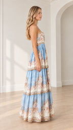 Side profile view of model in light blue floral tiered maxi dress