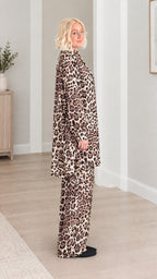 Side profile view of model wearing the brown leopard print matching two-piece set
