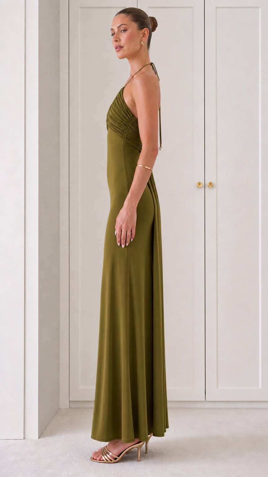 Side view of woman in Olive Green backless halter evening dress