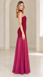 Side profile of burgundy strapless drop waist evening gown