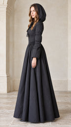 Side profile view of black hooded maxi ball gown coat showing full skirt volume