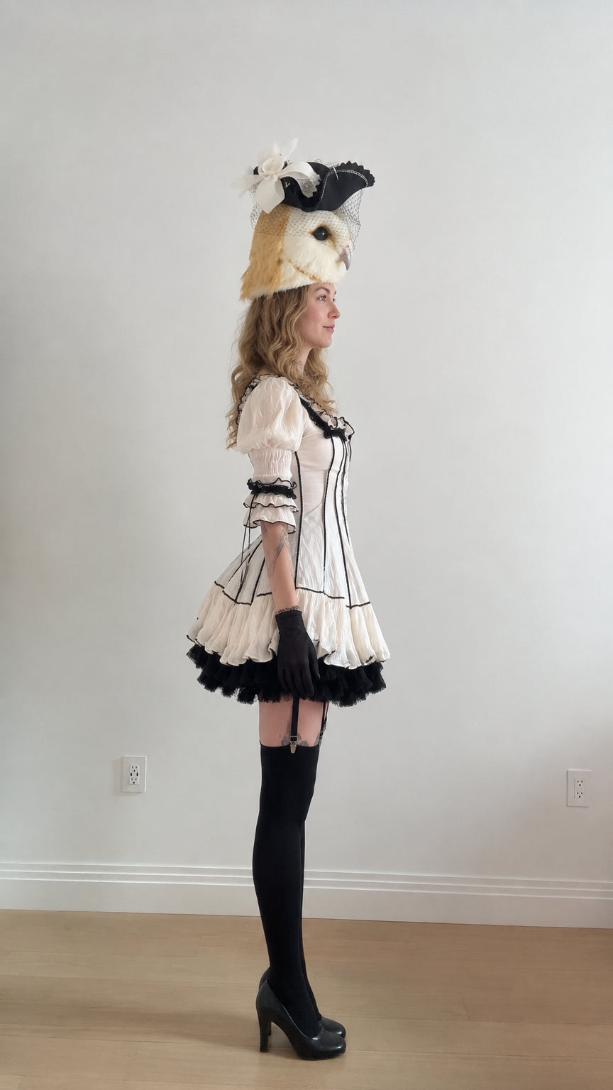 Side profile view of white lolita mini dress showing tiered skirt flare