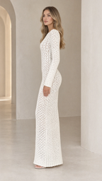 Side profile view of model wearing white crochet knit maxi dress