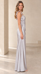 Side profile view of model posing in a silver ruched satin evening gown