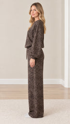 Side profile view of model wearing coordinated brown snakeskin print two-piece loungewear set