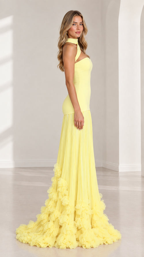Side profile view of yellow drop waist evening gown showing silhouette and tulle skirt