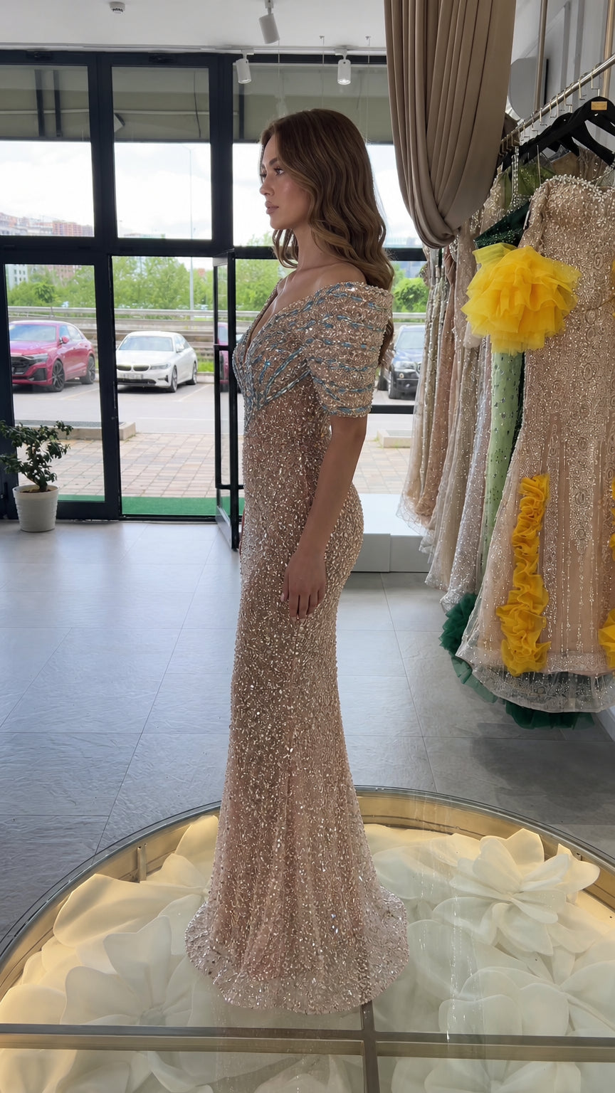 Side profile view of champagne floor-length sequin evening gown