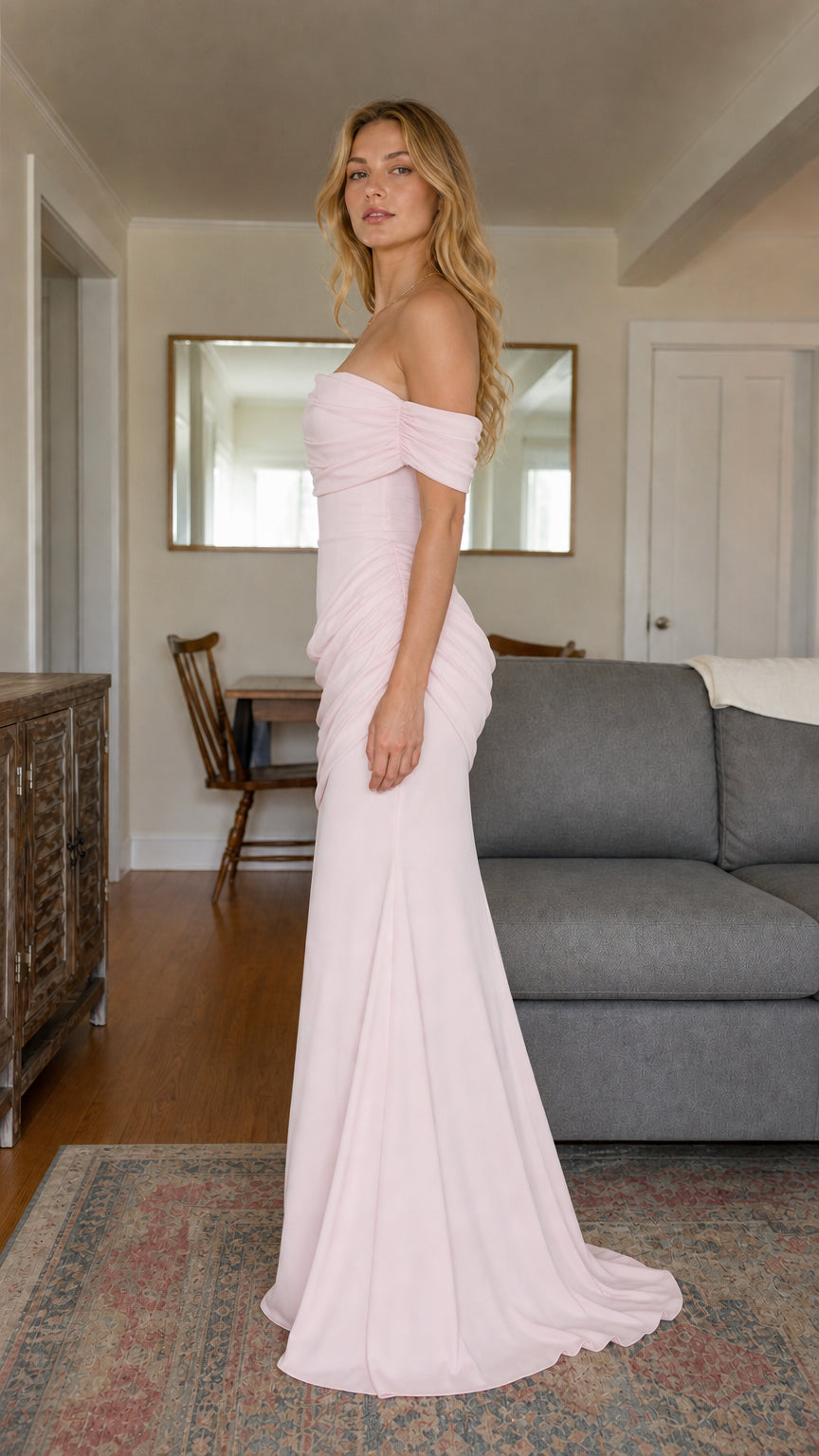 Side view of woman wearing blush pink off-the-shoulder formal maxi dress