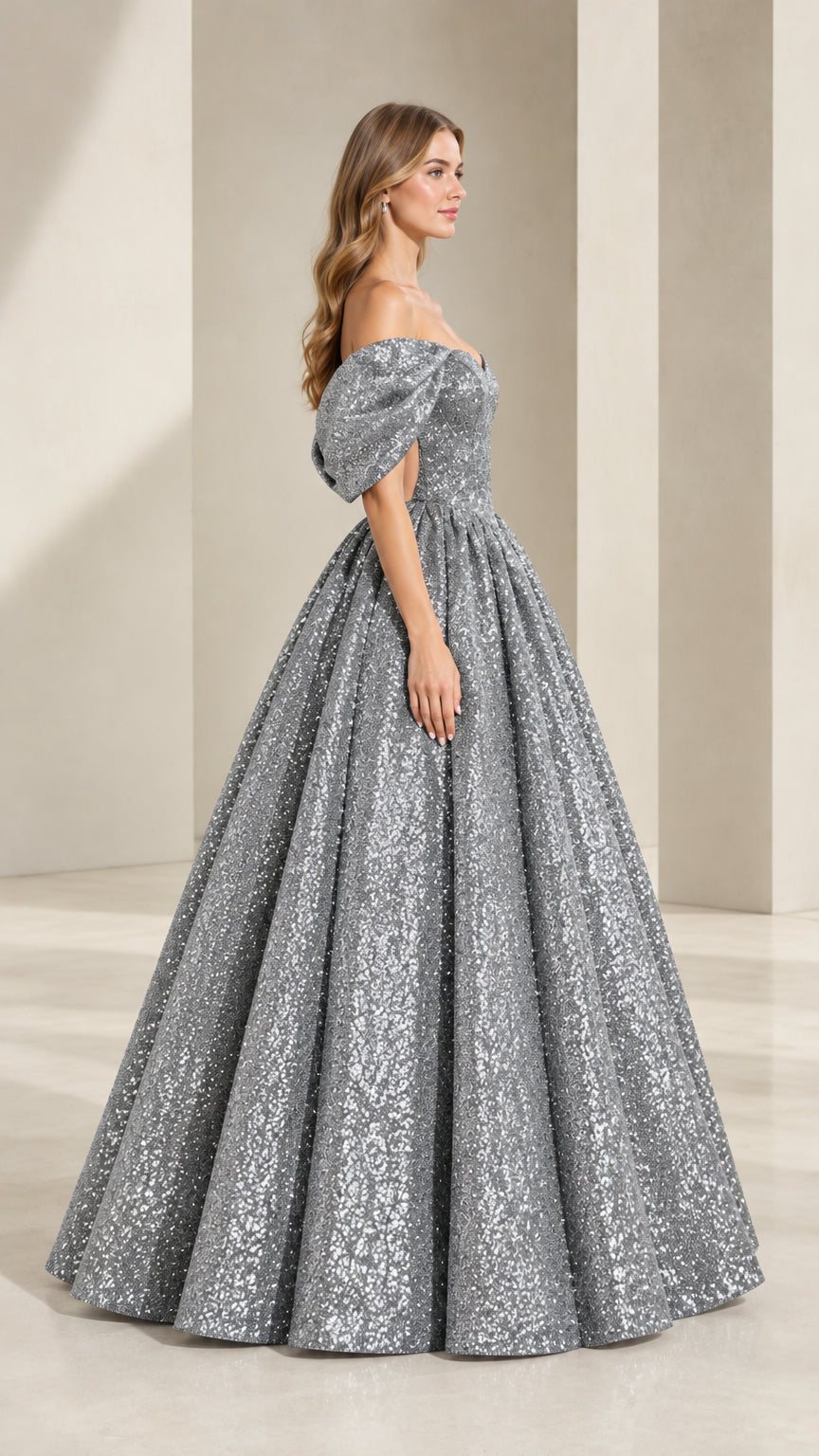 Side angle view of model posing in shimmering silver gray evening ball gown
