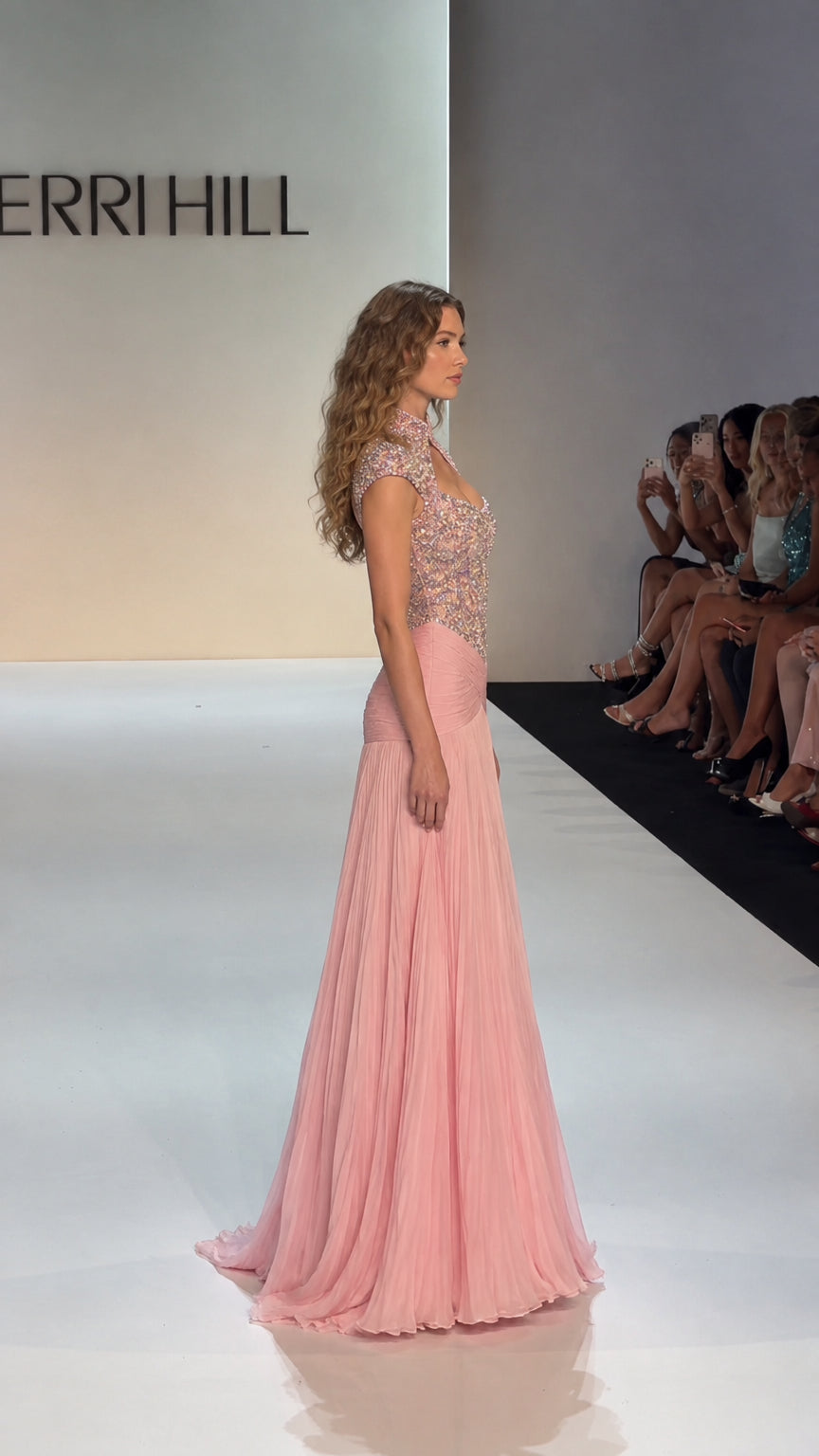 Side profile of blush pink beaded formal gown showing pleated skirt and silhouette