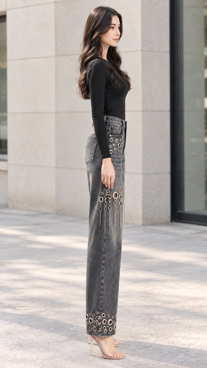Side profile of woman showcasing washed grey wide-leg jeans with chain fringe thigh cutouts