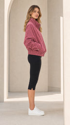 Side profile of woman wearing Dusty Rose casual stand collar jacket and white sneakers