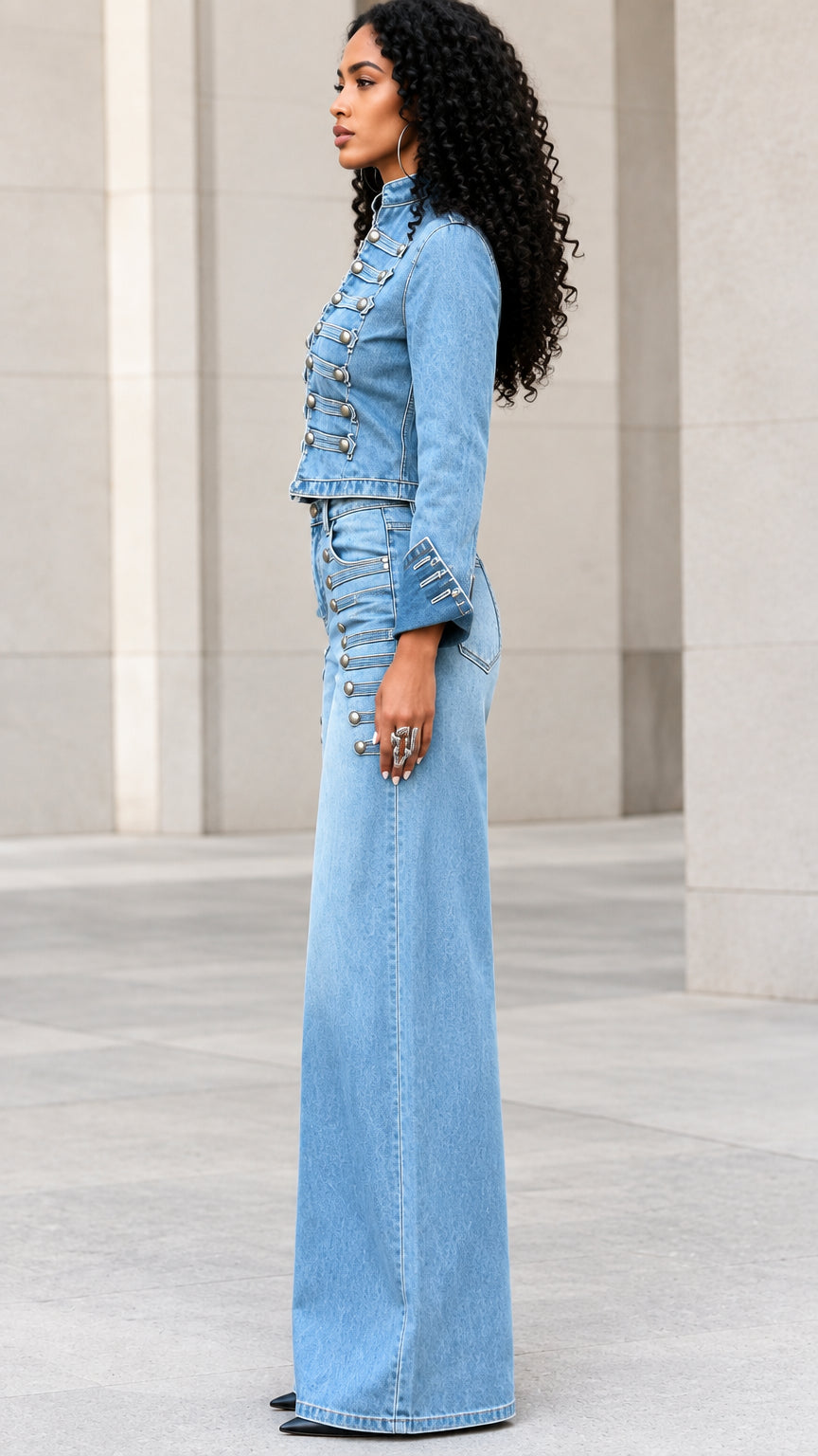 Side profile of model wearing light blue military cropped denim jacket and wide-leg jeans