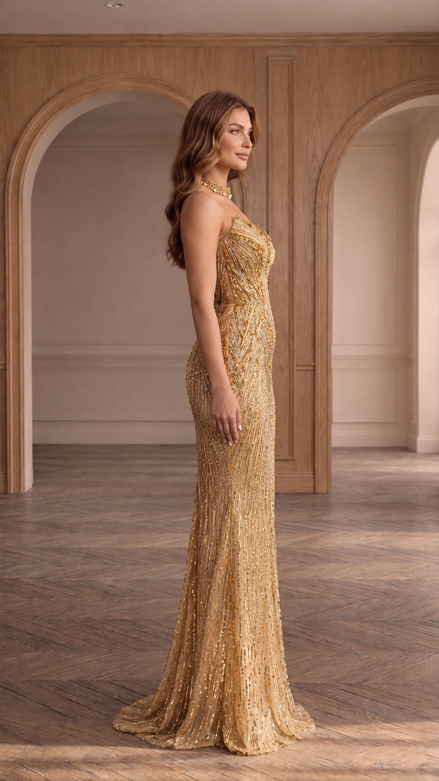 Side profile view of gold strapless embellished evening dress showing silhouette