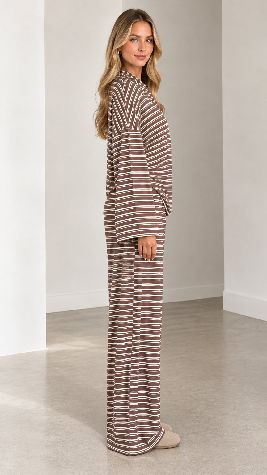 Side full-length view of brown striped two-piece loungewear set showing fluid drape