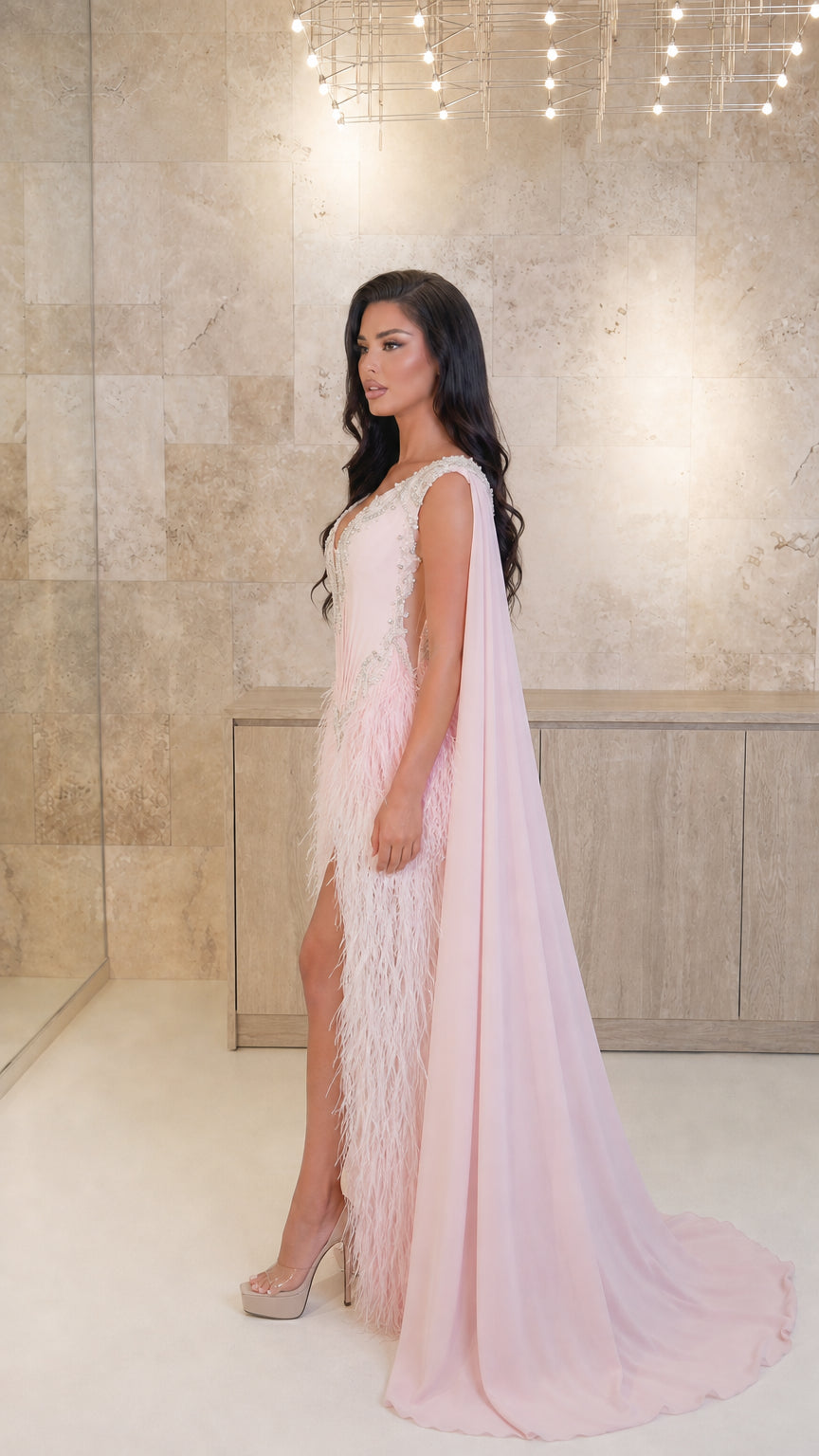 Model wearing Blush Pink embellished cape evening gown showing side profile and train