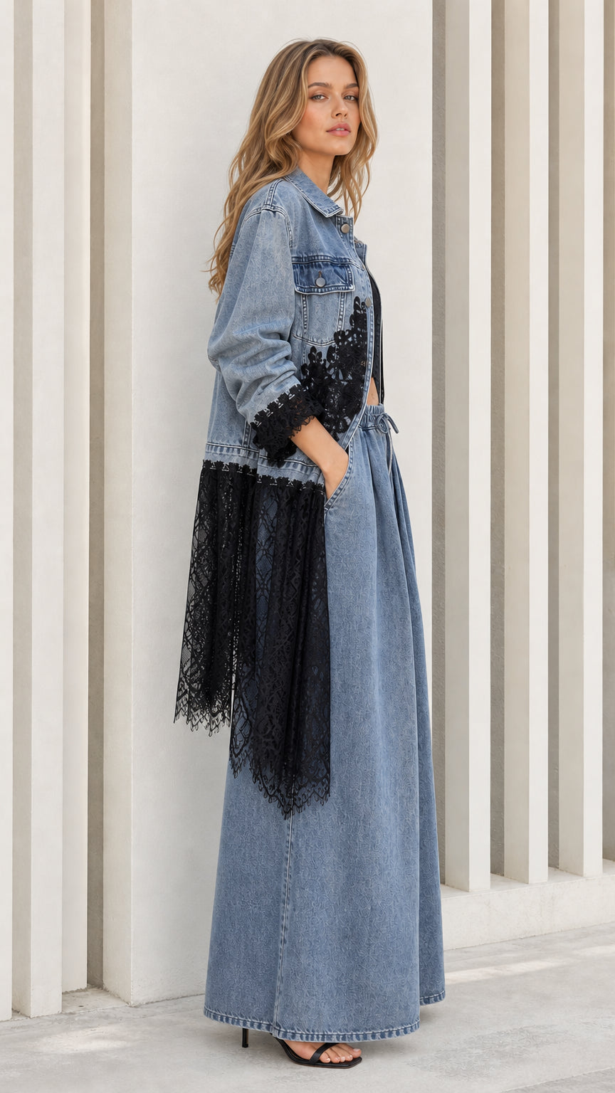 Side profile of light blue denim jacket with sweeping black lace peplum hem