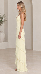 Side profile of model in pale yellow beaded v-neck tiered maxi gown