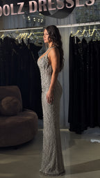 Side profile view of model in silver floor-length embellished formal dress
