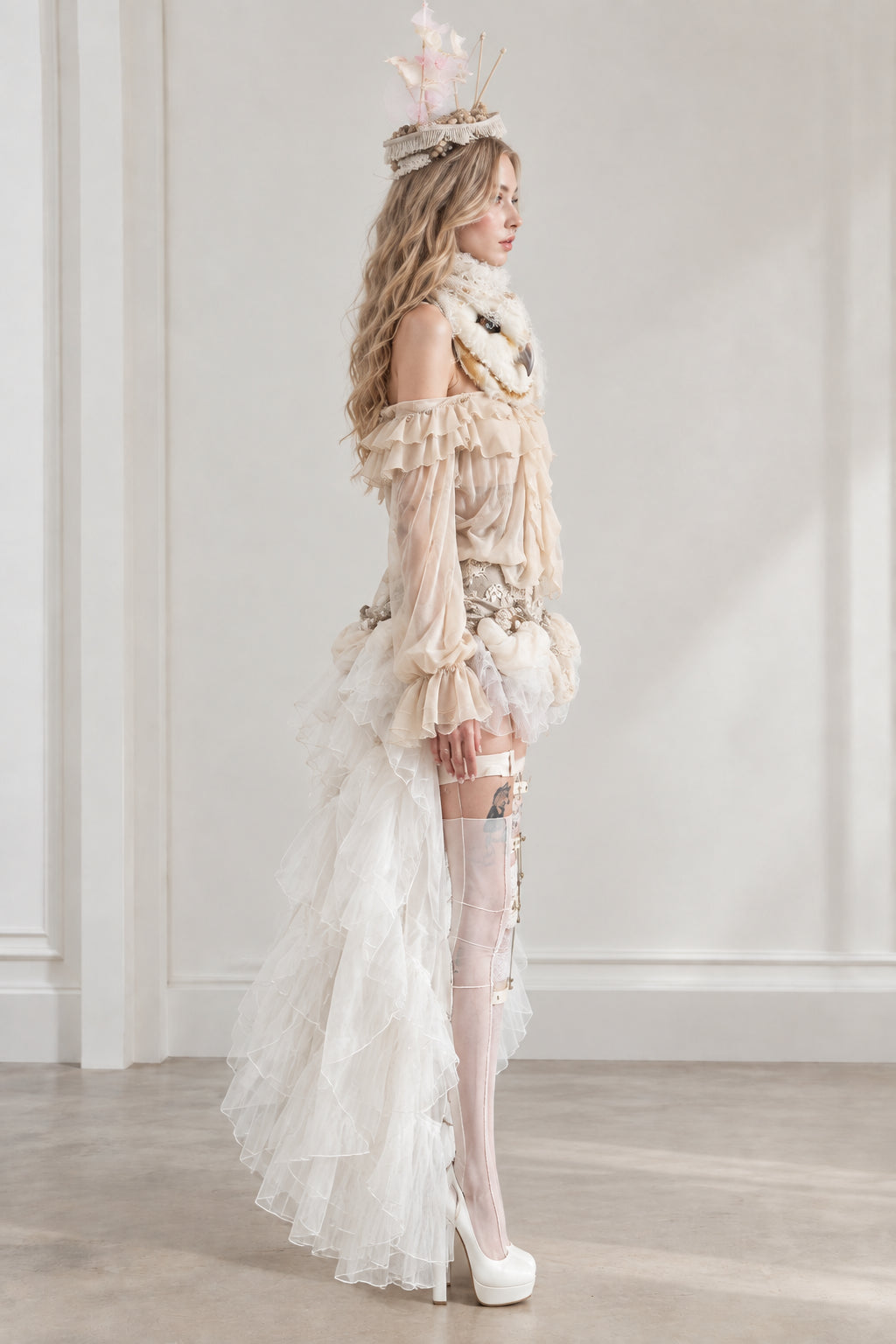 Side profile view of model in ivory tiered ruffle train costume set