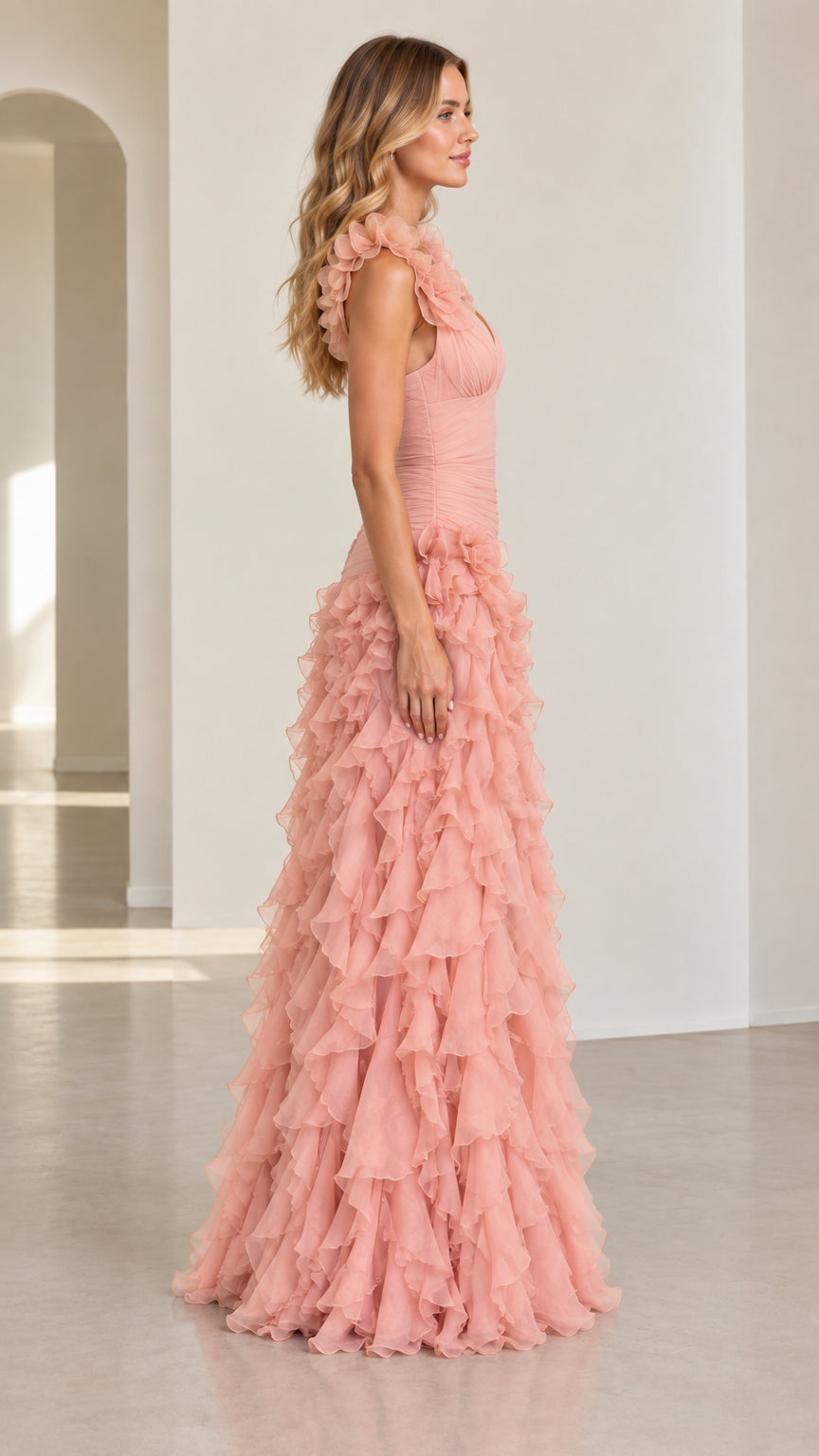Side view of model wearing dusty pink tiered flounce formal gown
