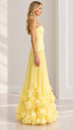 Side profile of strapless pastel yellow evening gown showing flowing pleated silhouette