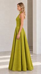 Side profile view of model showcasing structured A-line skirt of olive green maxi dress