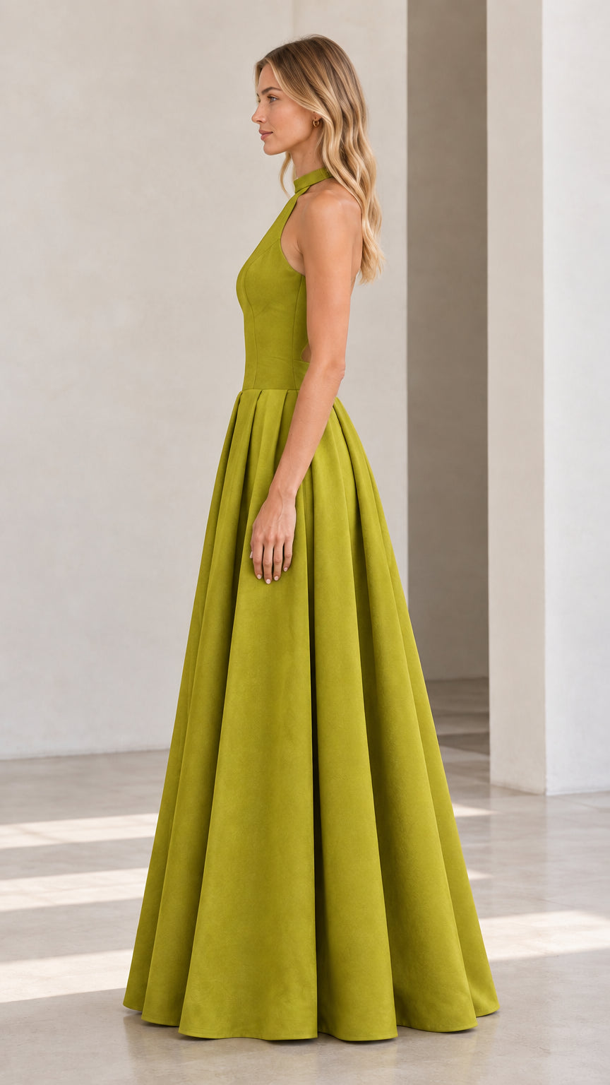 Side profile view of model showcasing structured A-line skirt of olive green maxi dress