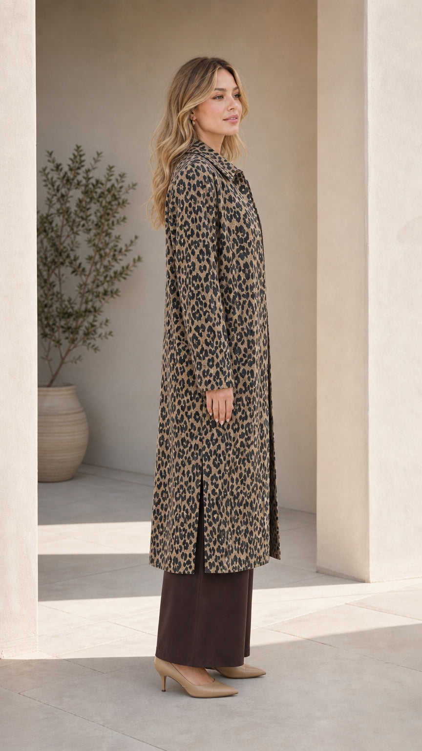 Side view of woman in Classic Tan leopard print coat showing side slit detail