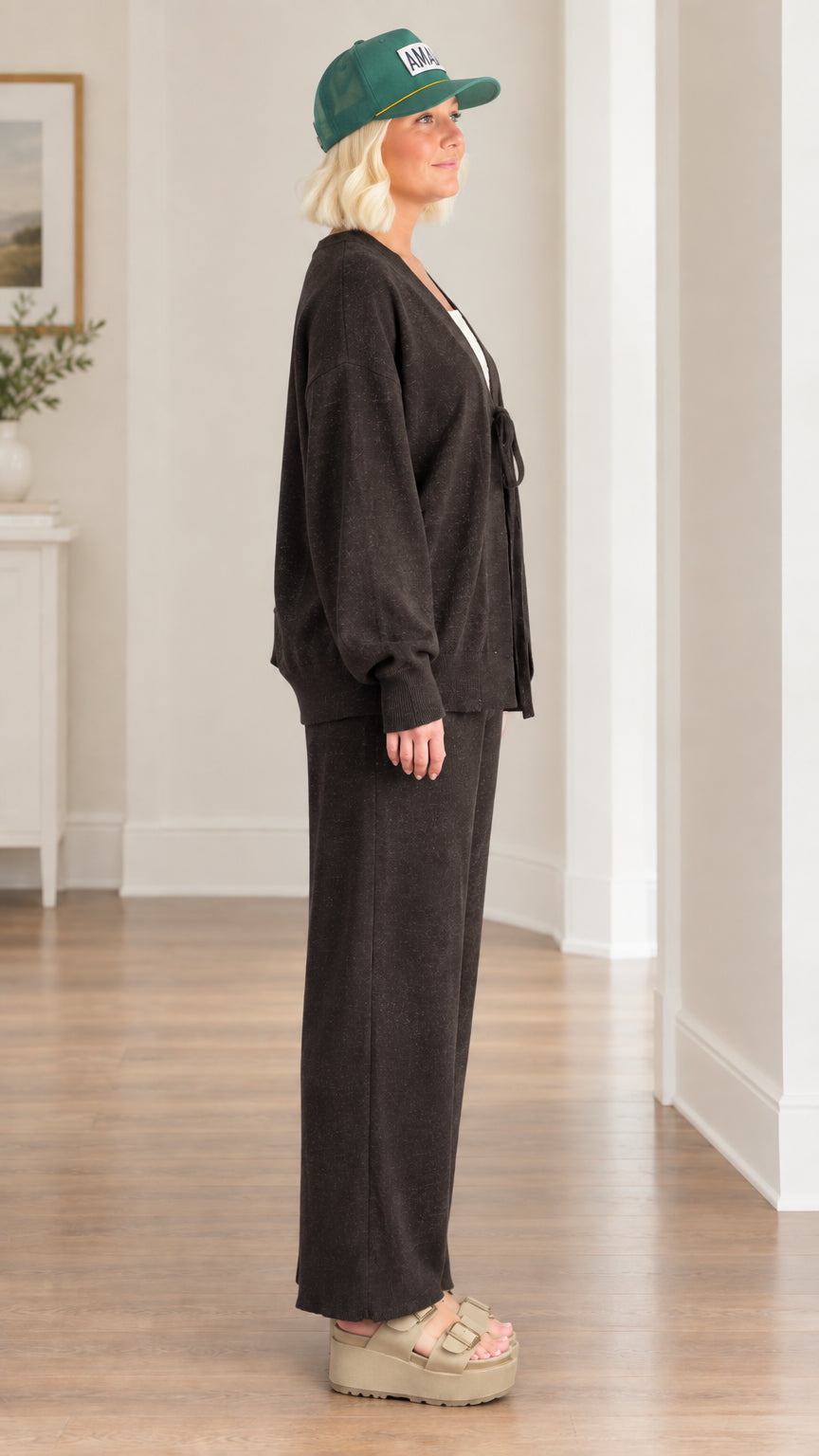 Side profile view of woman wearing charcoal knit cardigan and matching wide-leg pants