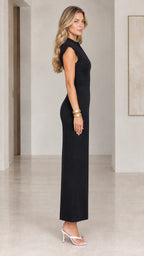 Side profile of model in sleek black cap sleeve column maxi dress