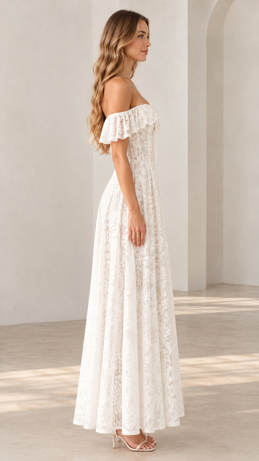 Side profile view of a woman wearing a white off-the-shoulder floral lace gown