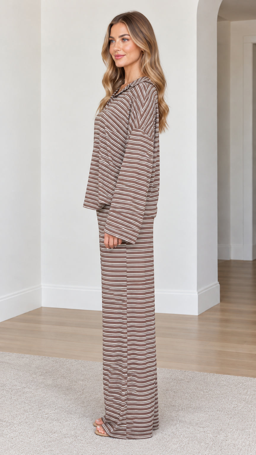 Side profile of model wearing brown striped knit lounge set with fluid wide leg trousers