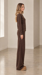 Side profile view of woman wearing brown ribbed knit two-piece lounge set