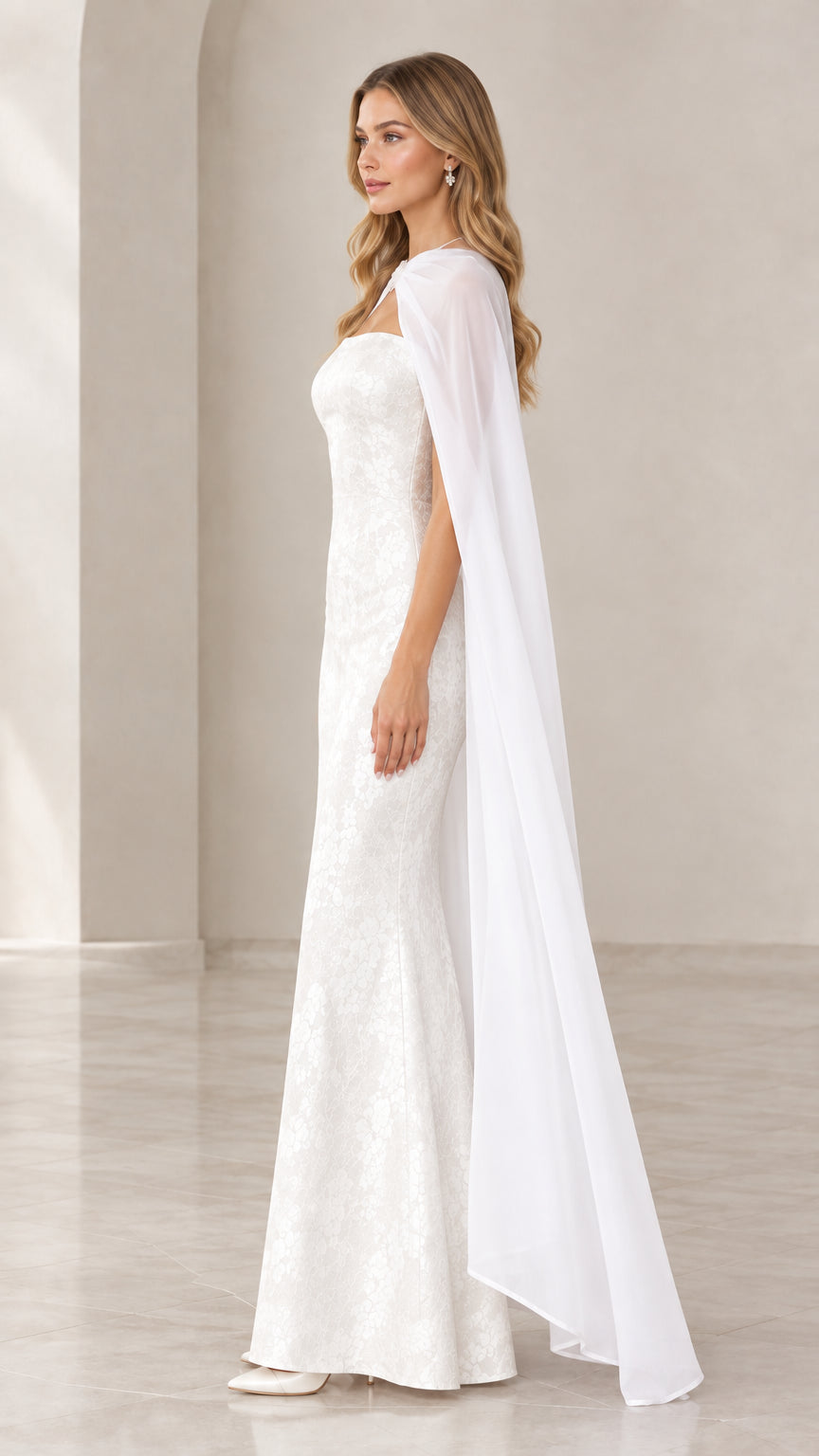 Side profile view of white lace strapless maxi dress and matching full-length sheer cape