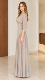 Side full-length view of woman in taupe elegant evening maxi dress
