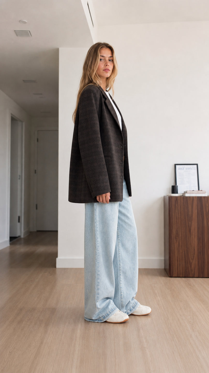 Side profile view of model wearing charcoal plaid boyfriend blazer
