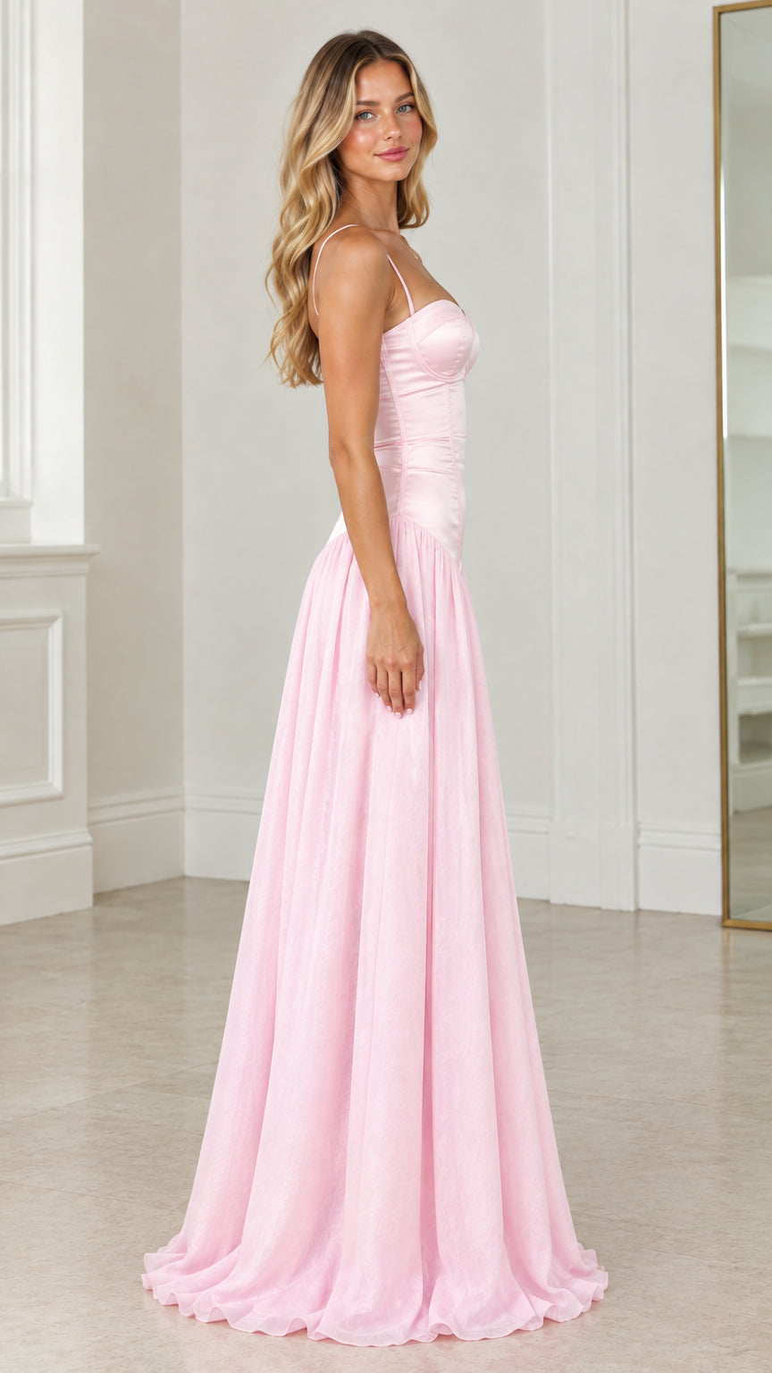 Side angle of model in light pink spaghetti strap bustier evening gown