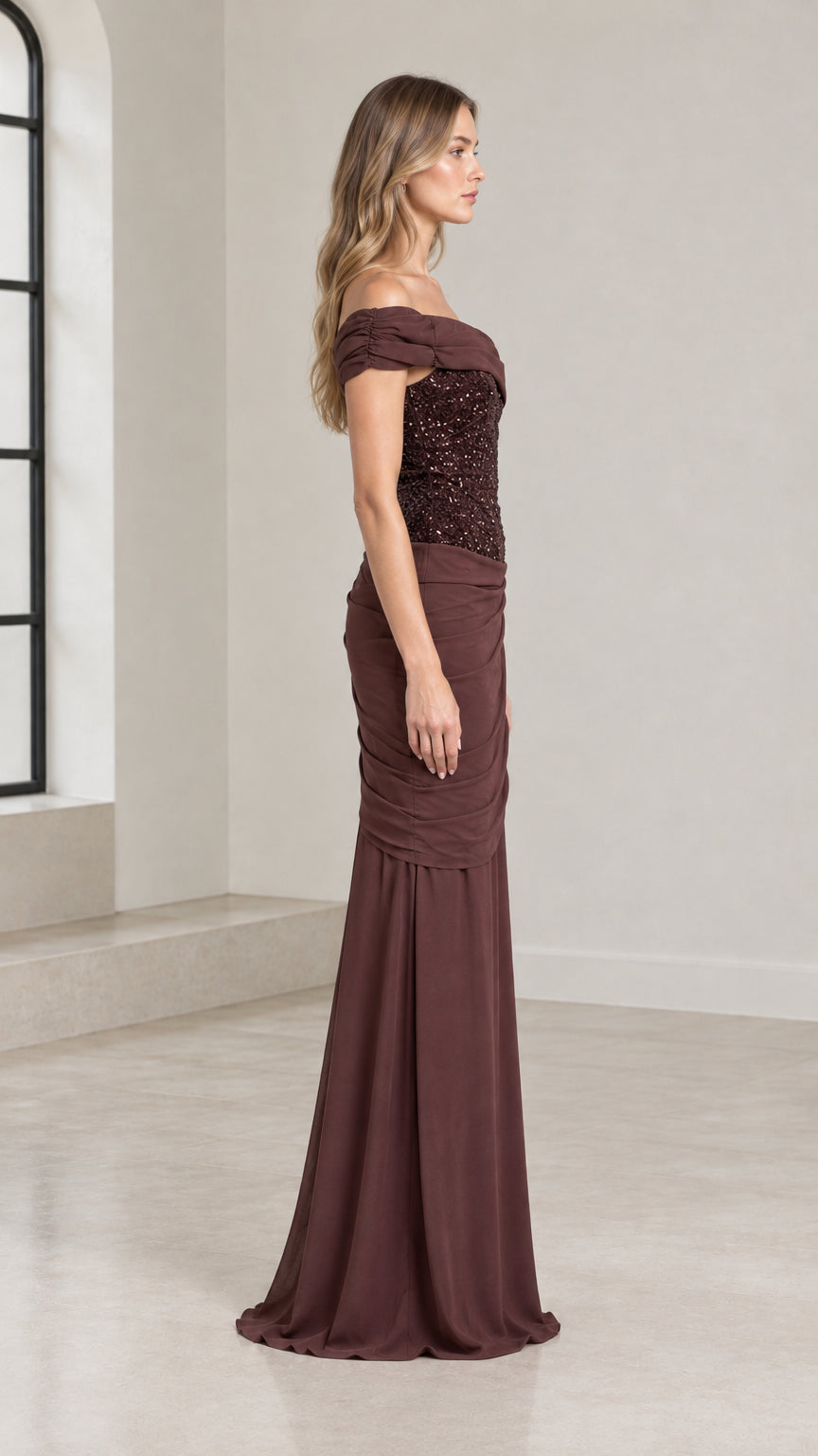 Side profile of chocolate brown floor-length formal gown with sequin bodice