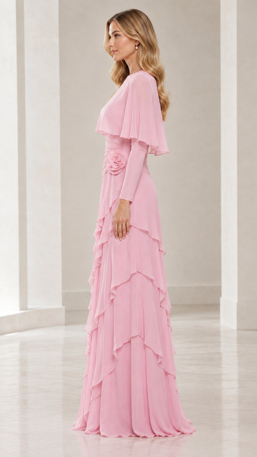 Side profile of model in pink long sleeve evening gown with capelet