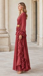 Side profile view of rust red pleated ruffle maxi gown showcasing cascading skirt ruffles