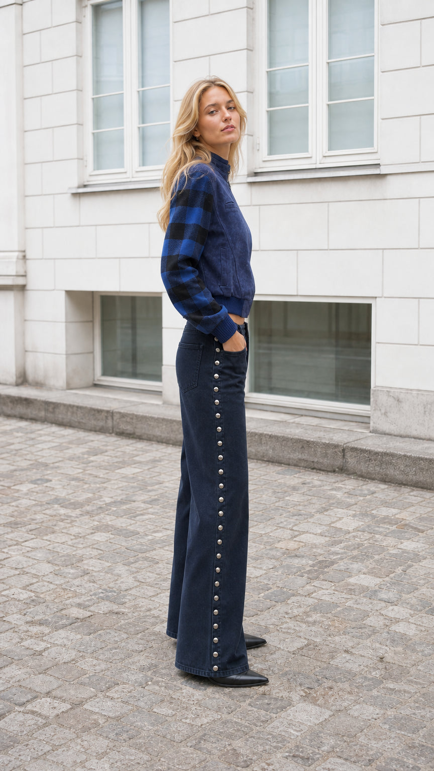 Side profile of model in Navy Blue cropped jacket with striped sleeves