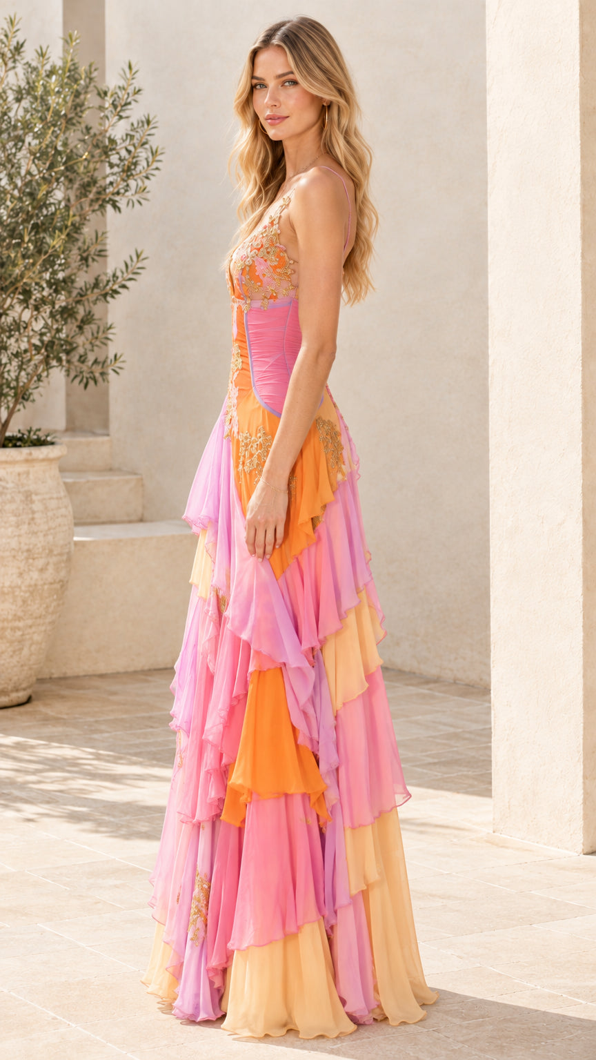 Side angle of model in pink multicolor tiered ruffle chiffon formal dress