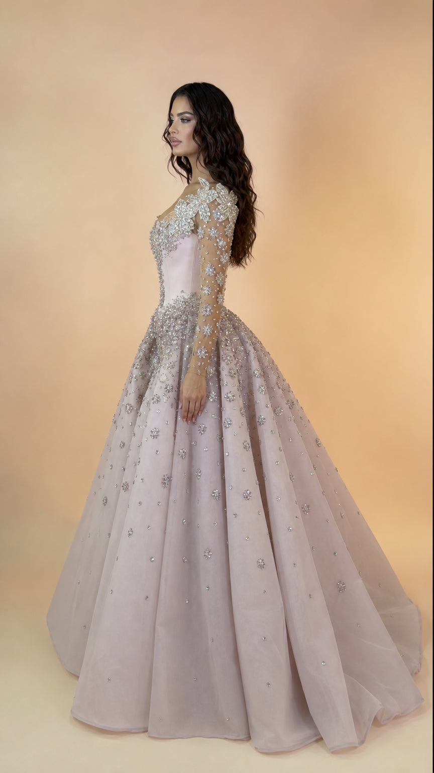 Side profile of blush pink embellished formal gown showcasing dramatic skirt volume