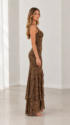 Side view of woman posing in brown floral jacquard tiered maxi dress