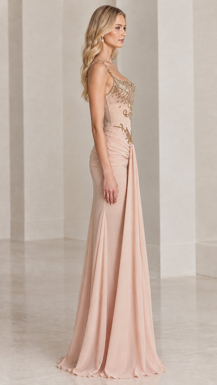 Side profile view of blush floor-length evening gown showcasing cascading side-front drape