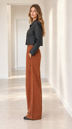 Side profile view of cropped quilted jacket and high-rise wide-leg pants