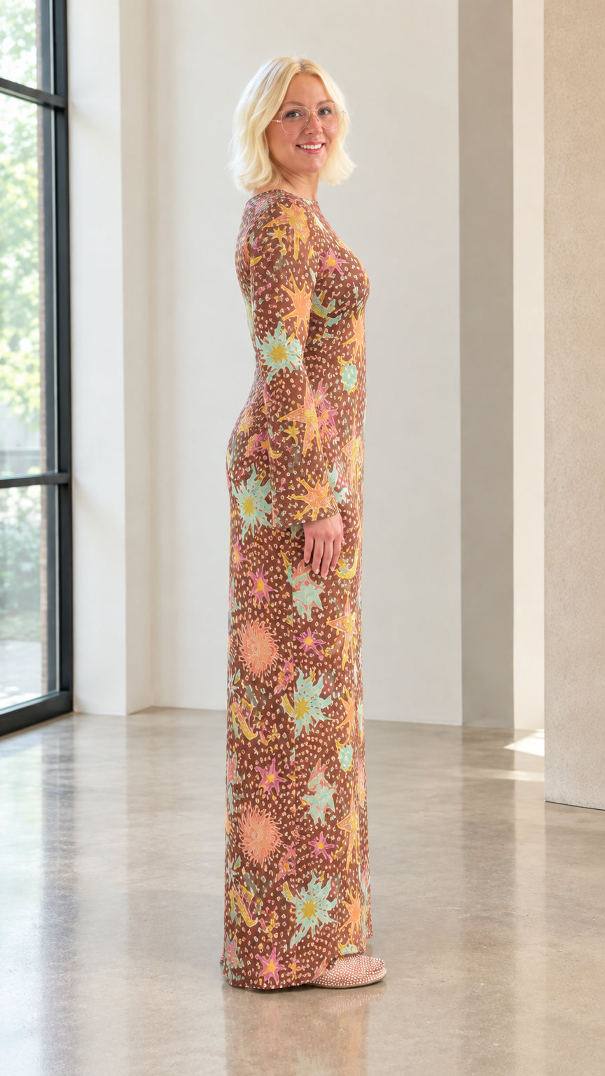 Side profile view of model wearing brown celestial sun and star print maxi column dress