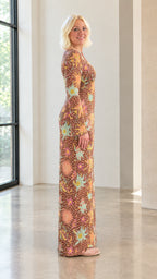 Side profile view of model wearing brown celestial sun and star print maxi column dress